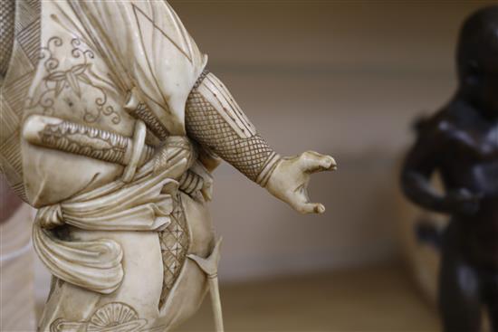 A Japanese ivory of a Samurai, Meiji period, 32.5cm, losses